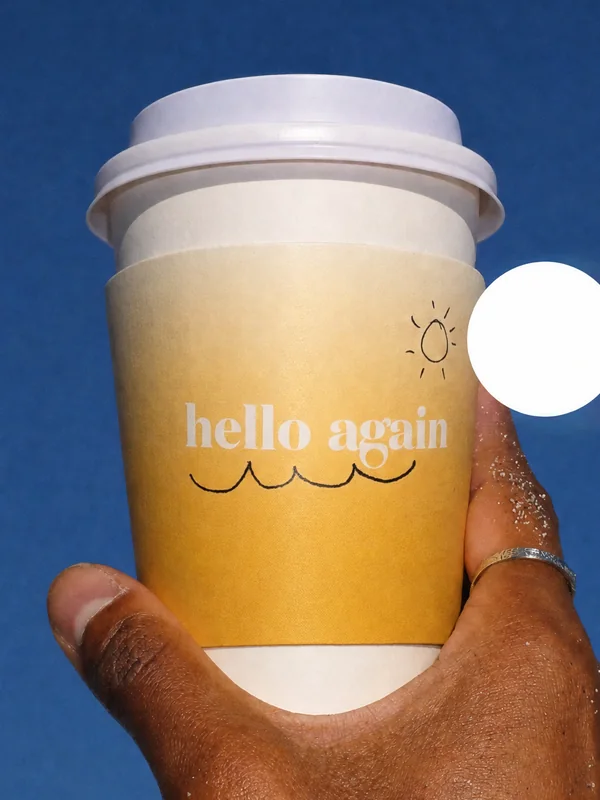 A rejected take: a cup held up to the sky with its sleeve running almost to the base