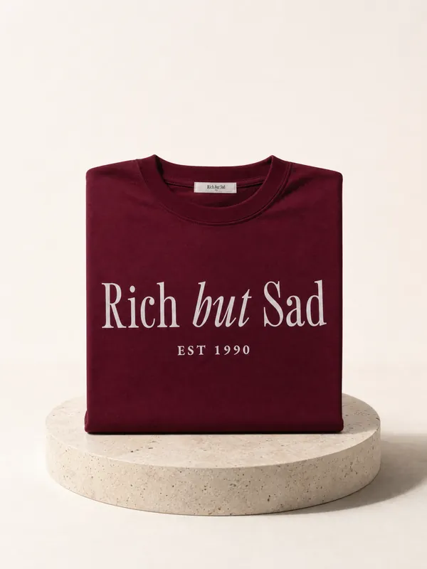 A rejected take: a folded tee standing on a stone plinth